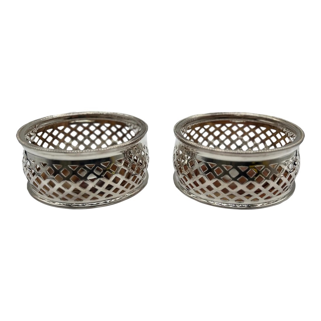 Pair, English Royal Castle Sheffield Bottle Holder or Coasters: A pair of vintage Royal Castle silverplated bottle holder or coasters with a pierced body and gadrooned edge. Marked to interior of each. Condition: Alterations: Original Condition Unaltered
