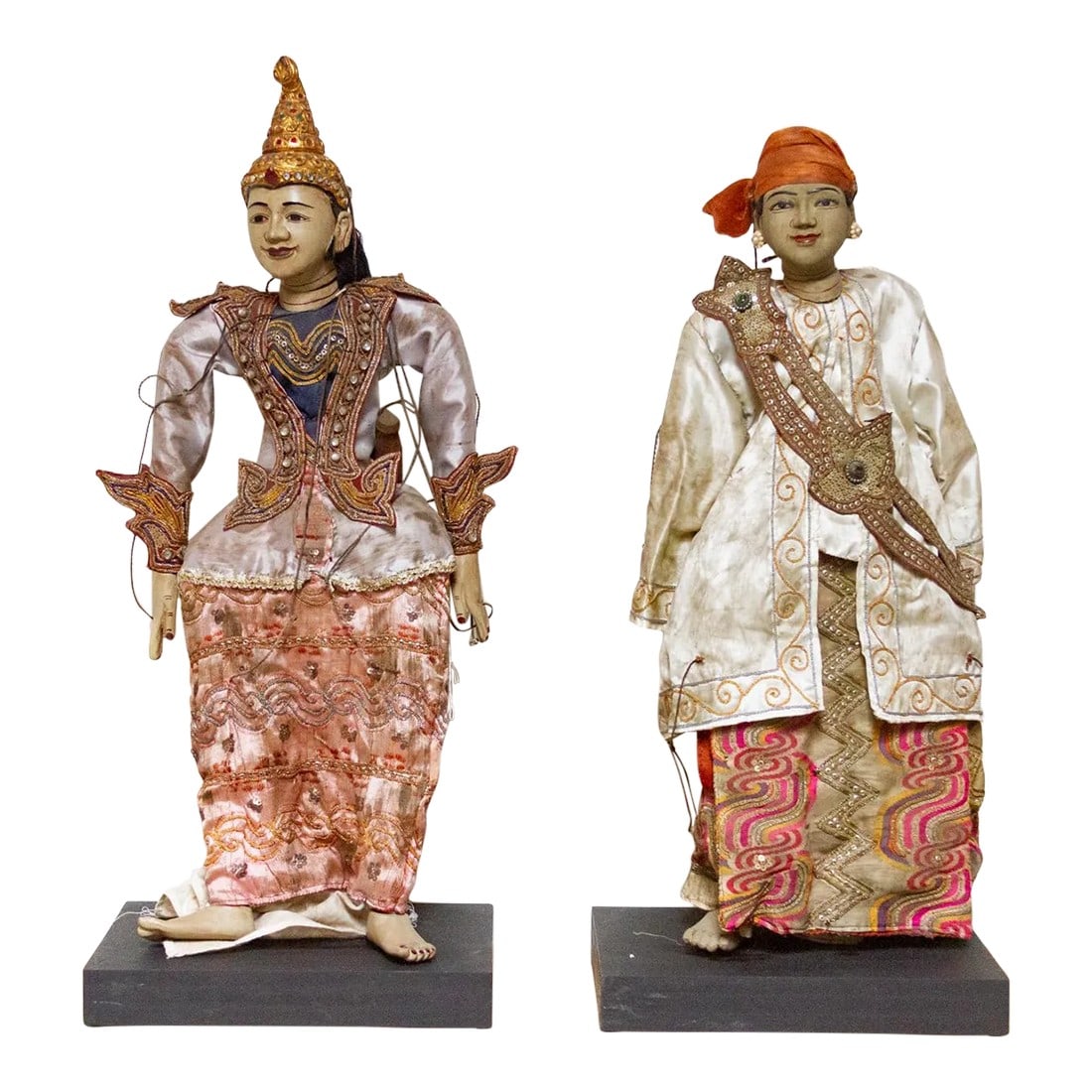 Set of Two Javanese Wayang Puppets: A splendid set of 2 Javanese Wayang Puppets, each a masterpiece of traditional craftsmanship. Adorned with fine silk fabric, these puppets exude elegance and authenticity. The intricate embroidery, do