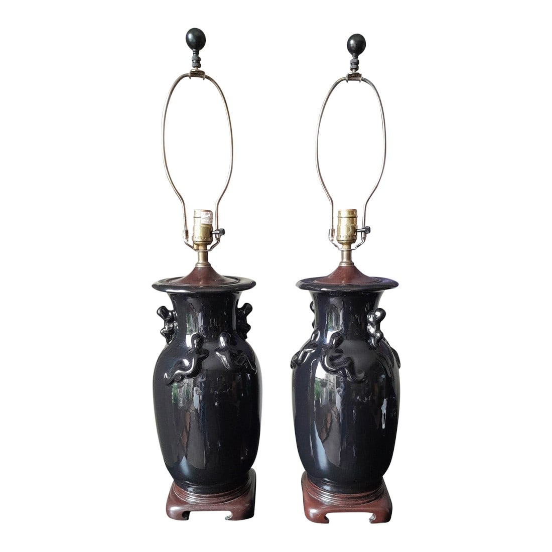 Mid 20th Century Chinese Gloss Black Salamander Decorated Porcelain Lamps - a Pair: A pair of Gloss Black Salamander Decorated Porcelain Vases Drilled As Lamps made by SPEER. Dark Mahogany Chow Footed Bases and Aged Brass Hardware. Lamps have 3 way sockets. Condition: Alterations: Re