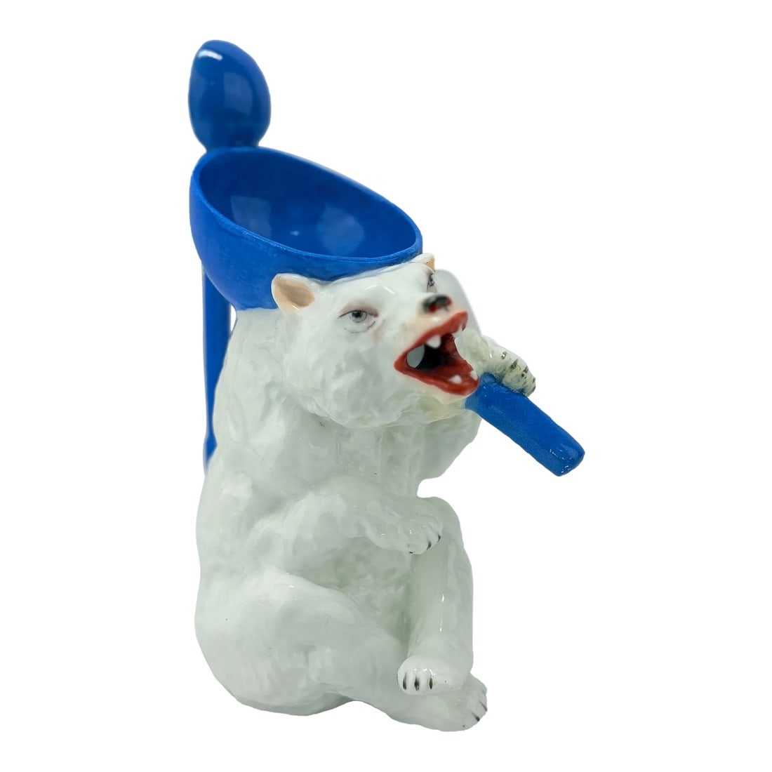 Antique German Polar Bear Form Porcelain Syrup Pitcher: This rare and whimsical Antique German porcelain syrup pitcher is crafted in the form of a polar bear, embodying both charm and fine craftsmanship. The bear is depicted with a fierce and expressive fa