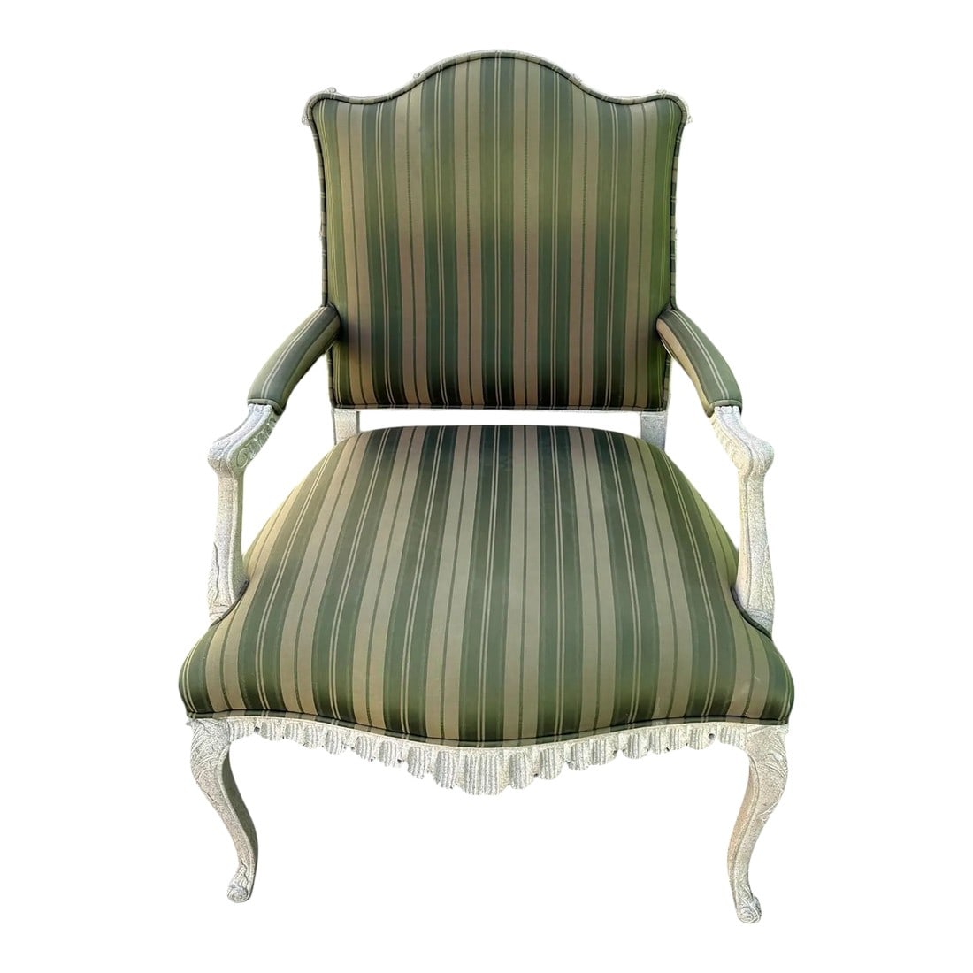 Late 20th Century Louis XVI Style Carved Wood Bergère Chair: Quick Hits: Late 20th-century Louis XVI-style bergère Intricately carved wood frame in painted ivory finish Luxe green striped upholstery with elegant fringe trim Timeless silhouette inspired by