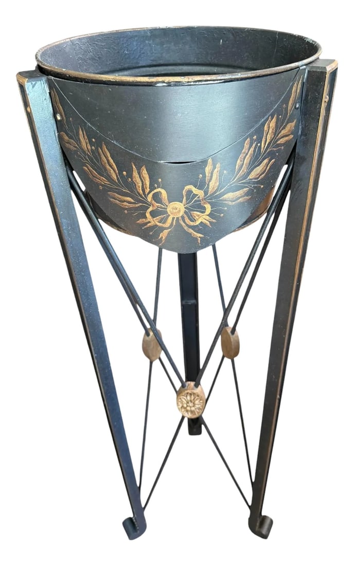 Late 20th Century Niermann Weeks Attributed Tole Jardiniere Plant Stand: Quick Hits: "• Attributed to luxury designer Niermann Weeks "• Classic black tole with gold floral detailing "• Tapered tripod base with crisscross metal supports "• Decorative