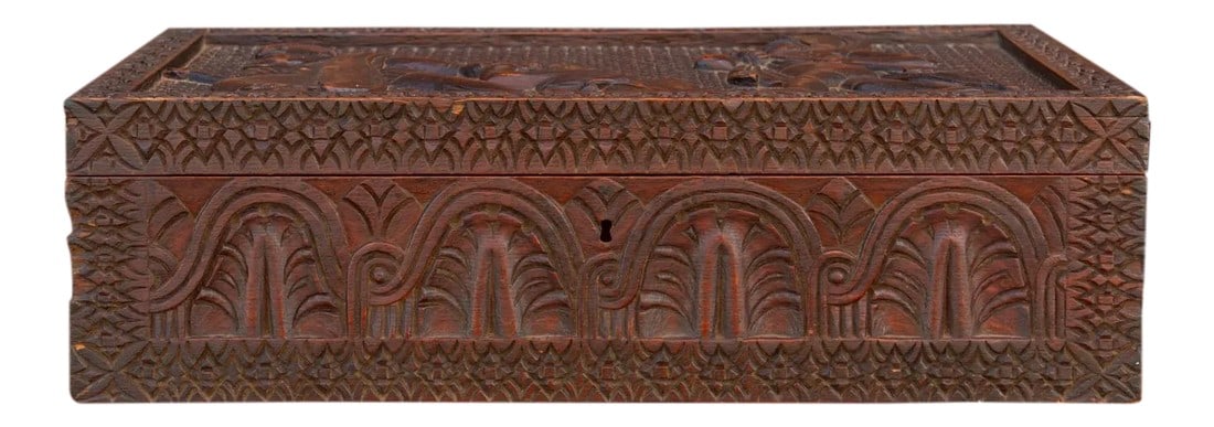 19th Century Anglo Indian Writing Box: Visually stunning, this 19th century Anglo Indian carved lap desk is a work of art. It has finely carved designs all around including a figwal scene on top. It opens up to reveal a soft red fabric cov