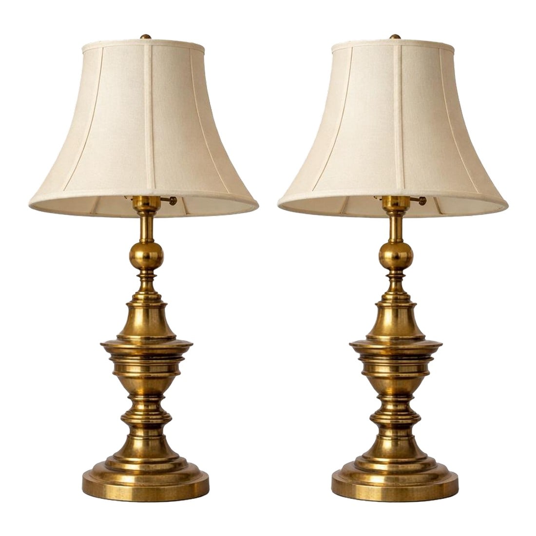 Vintage Solid Brass Table Lamps by Stiffel - a Pair: Classic pair of solid brass table lamps by Stiffel, featuring elegant turned profiles, warm original patina, and tailored ivory shades. Timeless American craftsmanship with refined traditional presenc