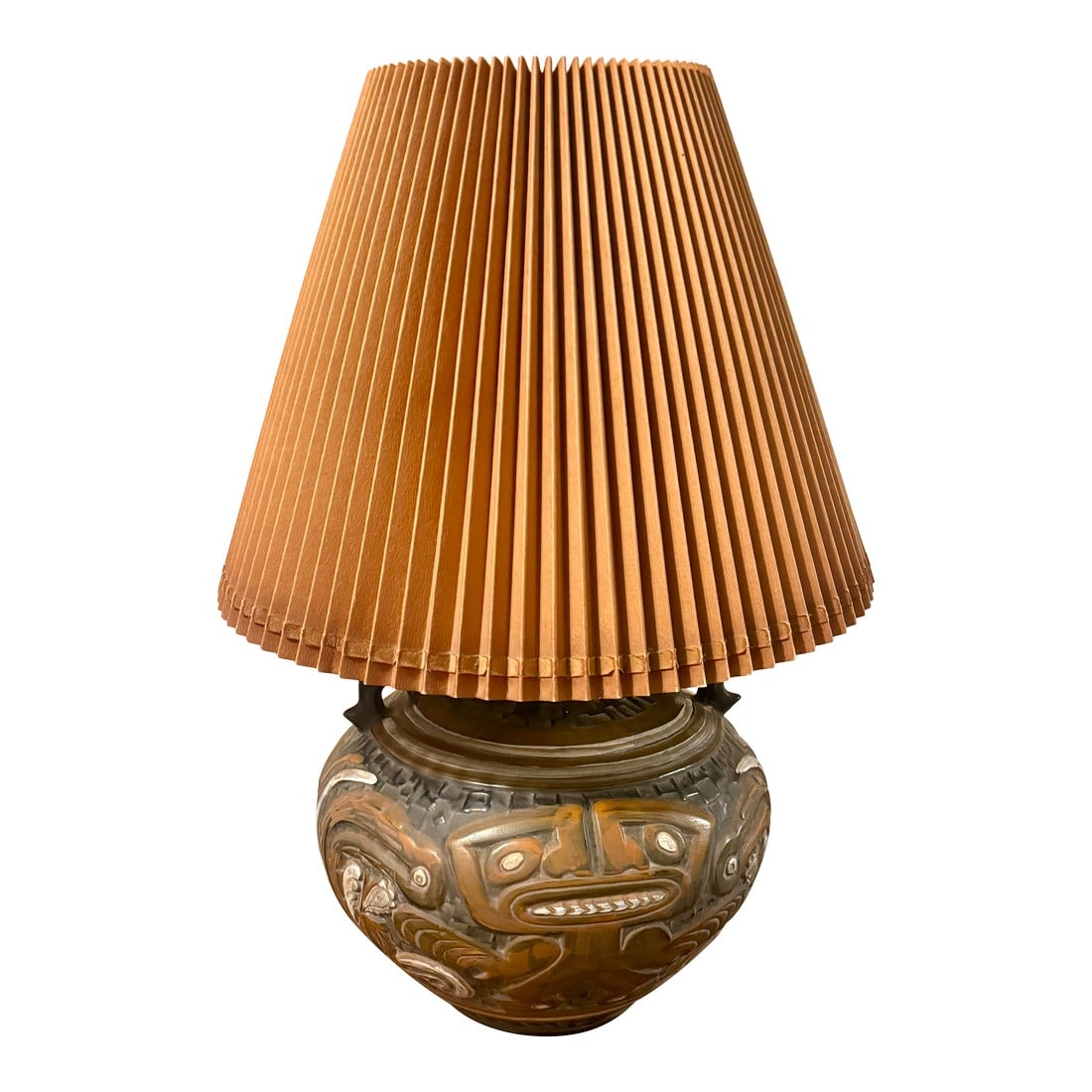 1970 Tiki Mayan Gods Lamp: This captivating large lamp's focal point is the deeply carved or molded relief figures with distinct faces and geometric patterns that evoke ancient Mayan or Aztec tribal artistry. Adding to its aged