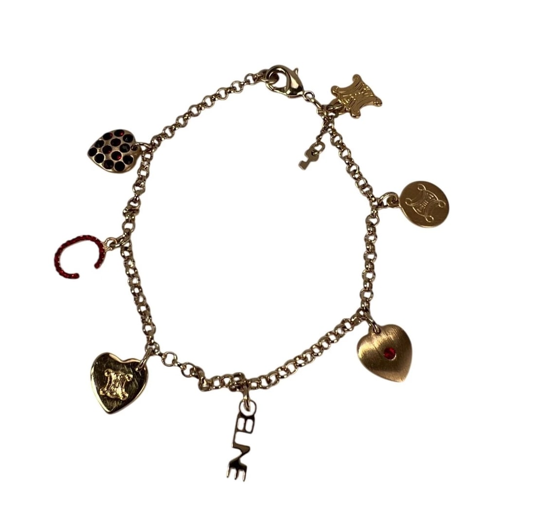 Celine Triomphe Gold metal Charm Bracelet: Title: Celine Triomphe Gold metal Charm Bracelet Description: Preowned 100% Authentic Celine Triomphe Gold metal Charm Bracelet RATING: A...excellent, near mint, has little to no signs of wear BRACELE