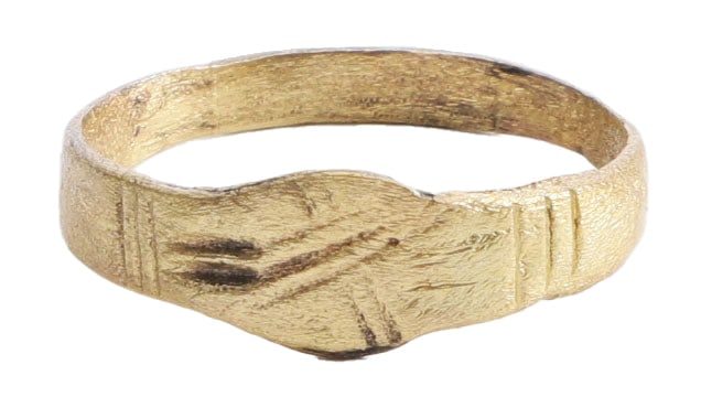 FINE ROMAN WOMAN’S RING, 2nd-5th CENTURY AD, SIZE 7 1/2: Gilt bronze with 2.6mm flat faced band flaring to the ribbed shoulders. Oval bezel cut with a two stroke X extending to the shoulder one side. On a man’s ring, this would serve as a signet, but