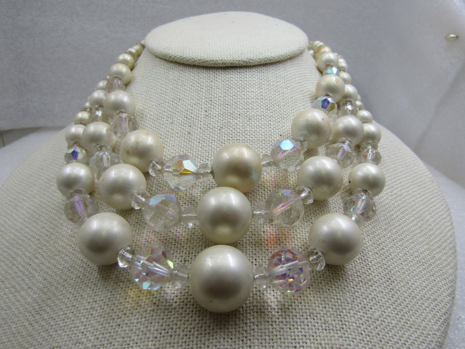 Vintage Faux Pearl Aurora Borealis Crystal Necklace, Triple Strand, 1940's,: Vintage Faux Pearl Aurora Borealis Crystal Necklace, Triple Strand, 1940's, 15" from hook clasp to the end of the extender chain. Graduated beads and faux pearls from 6mm to 15.5mm. The end caps have