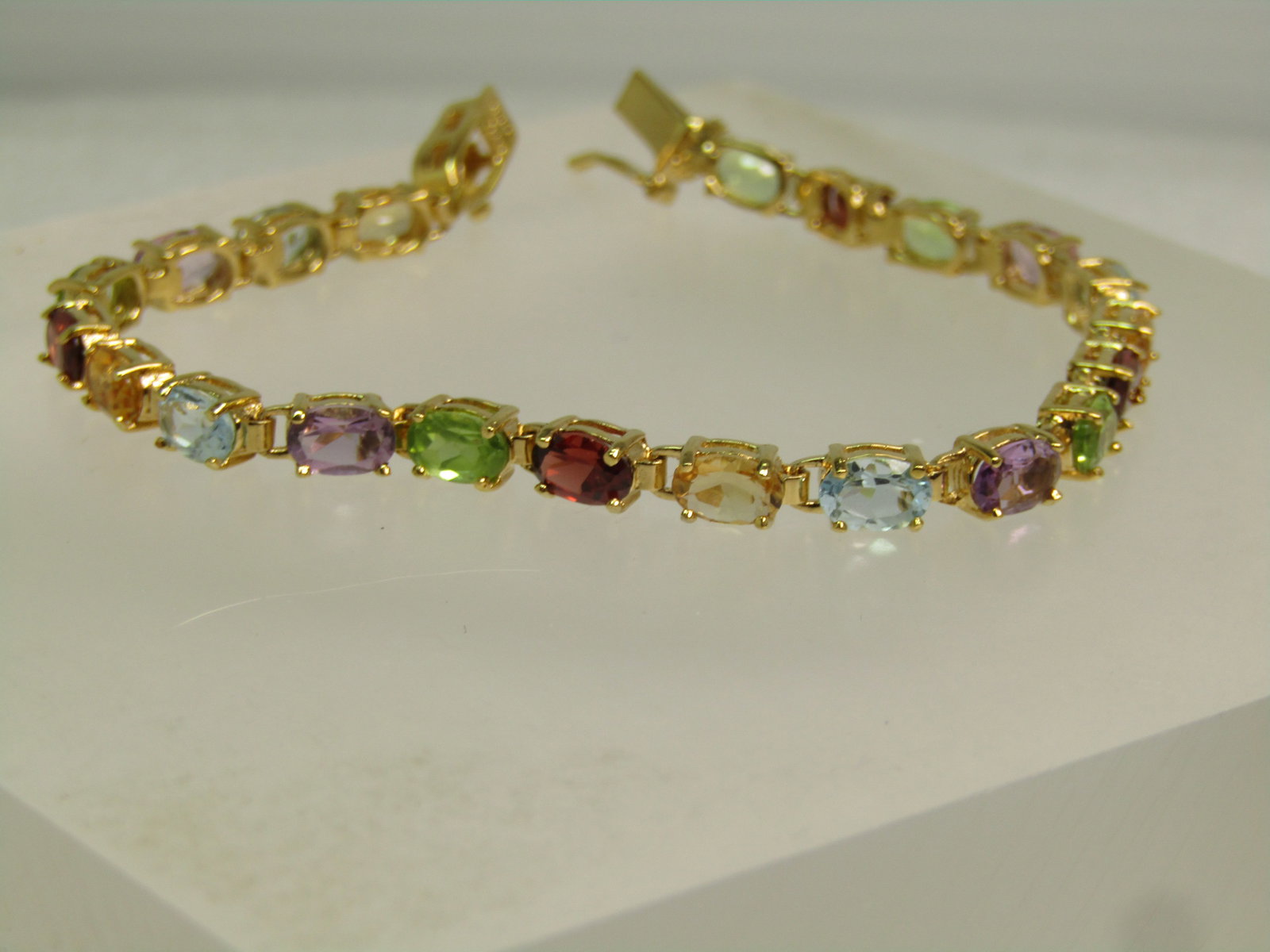 Sterling Gemstone Tennis Bracelet, 7", Gold Over, Signed R, 1990's: Sterling Gemstone Tennis Bracelet, 7", Gold Over, Signed R, 1990's. This is marked sterling, with box clasp with side safety. Weight is appx. 8.75 grams. Twenty-one oval prong-set stones that are appx