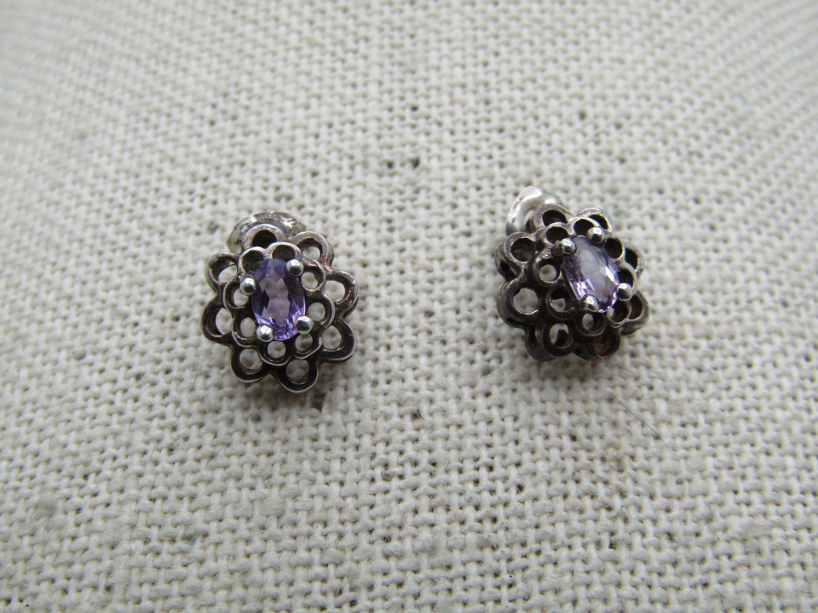 Vintage Sterling Amethyst Tiered Earrings, Pierced, 1980's-1990's.: Vintage Sterling Amethyst Tiered Earrings, Pierced, 1980's-1990's. Scalloped two tiers with open work and a center 4.5mm by 3mm oval amethyst set top center. The earrings are appx. 10mm across