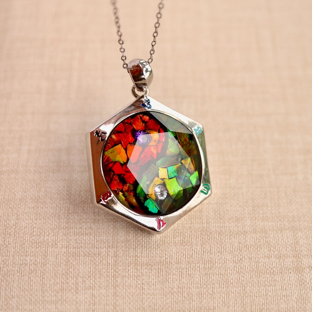 Natural Ammolite Hexagram Pendant: Title: Natural Ammolite Hexagram Pendant Description: This pendant perfectly showcases the charming allure of natural iridescent stones, which originated in the dinosaur era. Each iridescent stone is