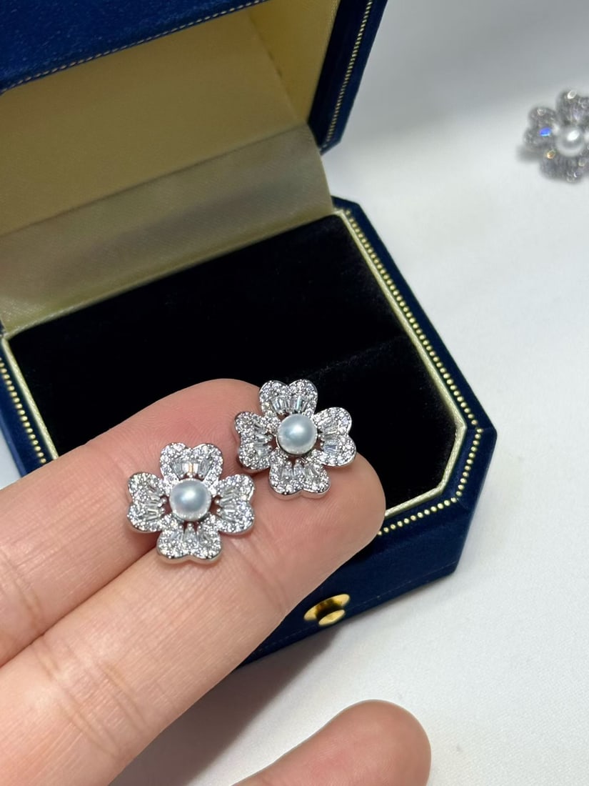 Silver pearl earrings: Title: Silver pearl earrings Description: These earrings capture the essence of elegance with their exquisite design. Each pearl is a bright flawless perfect sphere, emitting a charming radiance that