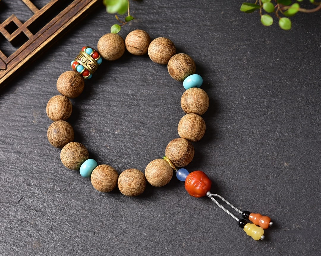 Agarwood bracelet: Title: Agarwood bracelet Description: This exquisite agarwood bracelet is a masterpiece of craftsmanship, meticulously carved from a single piece of high-quality soft silk agarwood. Its rich fragrance