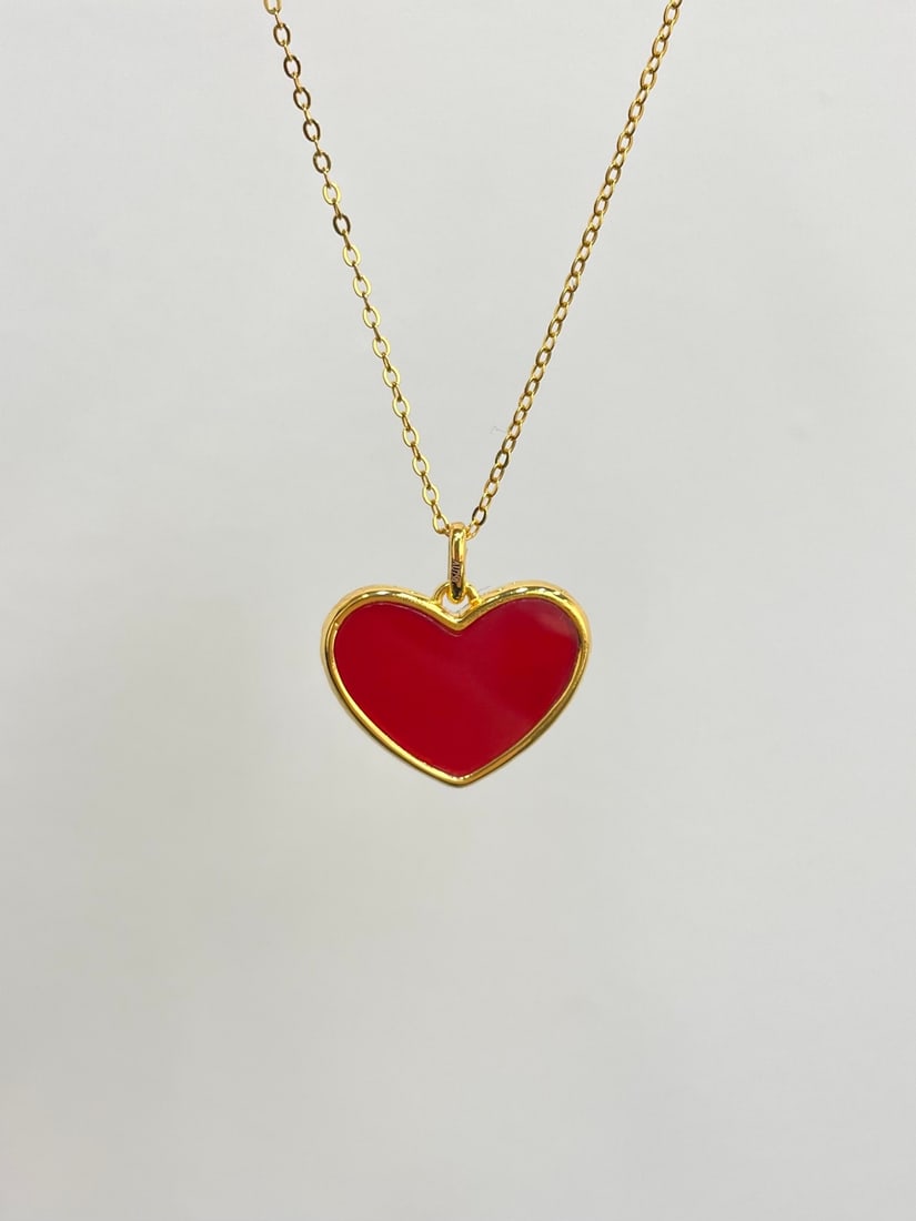 18K Gold Agate Pendant: Title: 18K Gold Agate Pendant Description: This pendant captures the essence of love with its exquisite heart-shaped design. Crafted from luxurious 18K gold, it features a striking black agate on the