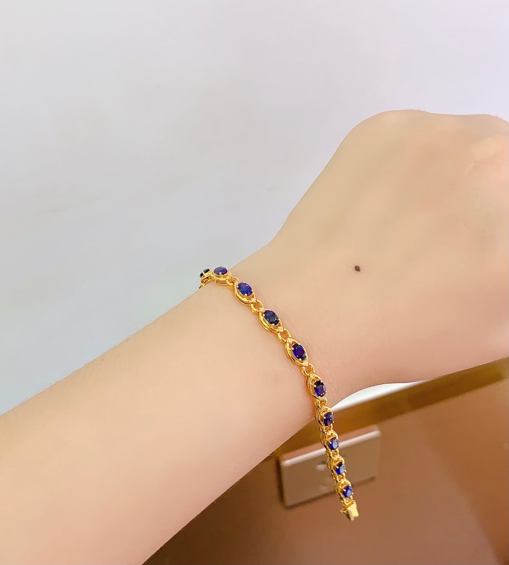 18K gold sapphire bracelet: Title: 18K gold sapphire bracelet Description: This bracelet is a perfect embodiment of luxury, with natural sapphires emitting a deep and enchanting blue light. The 18K gold setting enhances the