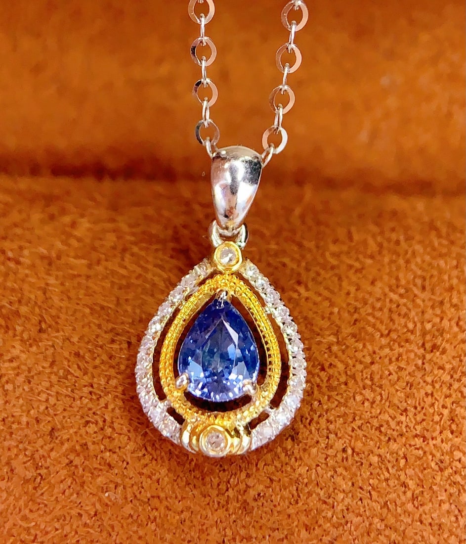 18K gold sapphire pendant: Title: 18K gold sapphire pendant Description: This pendant features a natural sapphire as the main stone, emitting a charming blue light, with 18K gold setting adding luxury and elegance. Whether for