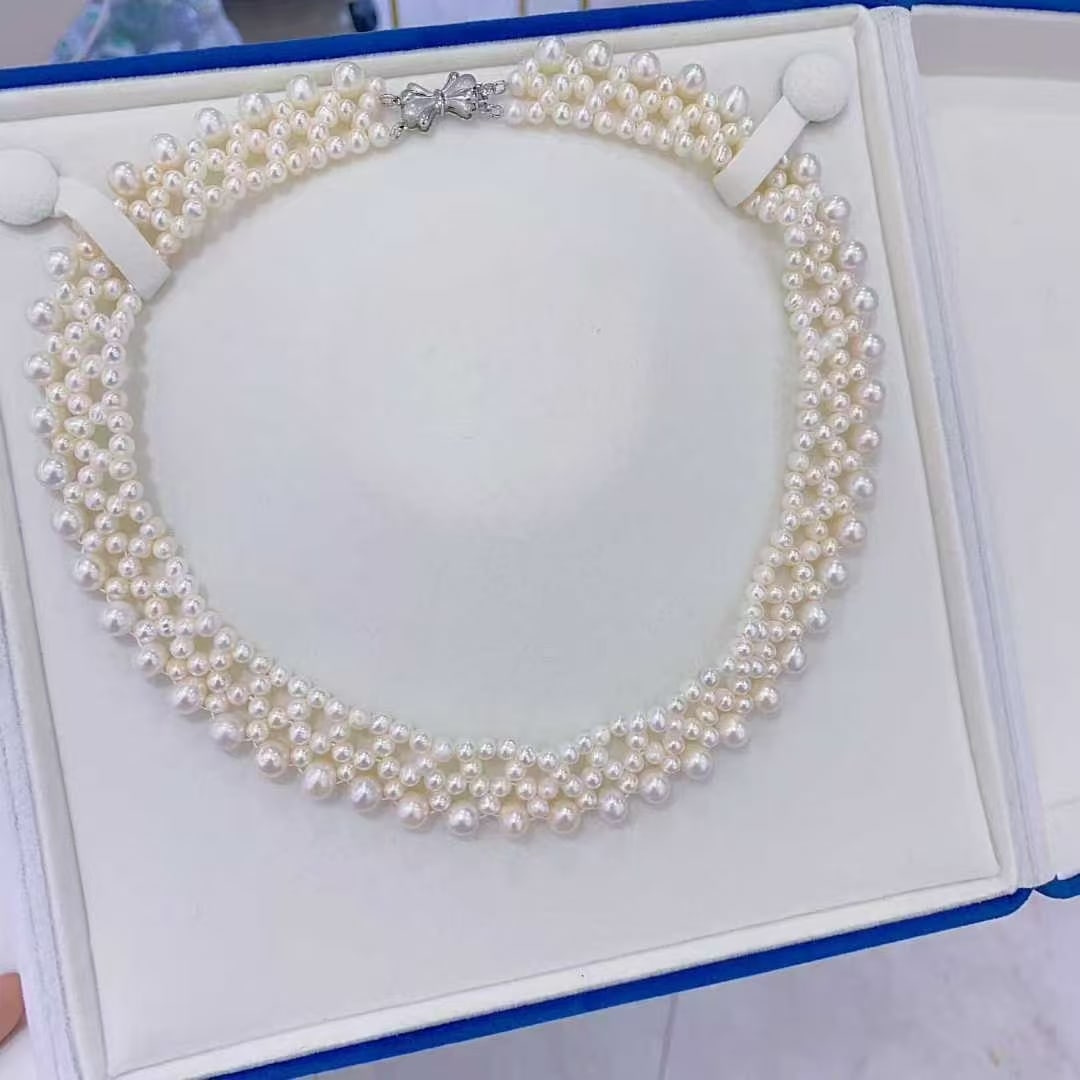 Natural freshwater pearl necklace: Title: Natural freshwater pearl necklace Description: This natural freshwater pearl necklace is crafted using hand-woven techniques, with each pearl presenting a nearly round shape and emitting a