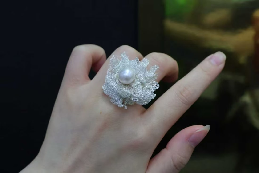 Edison Freshwater Pearl Ring: Title: Edison Freshwater Pearl Ring Description: This ring features a natural freshwater pearl as the main stone, showcasing its high-quality characteristics of strong luster with slight flaws,