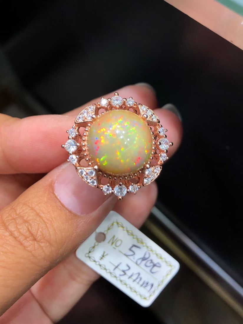 925 sterling silver opal ring: Title: 925 sterling silver opal ring Description: This ring features a natural iridescent opal as the main stone, showcasing a dreamlike color change that seems to condense the splendid colors of