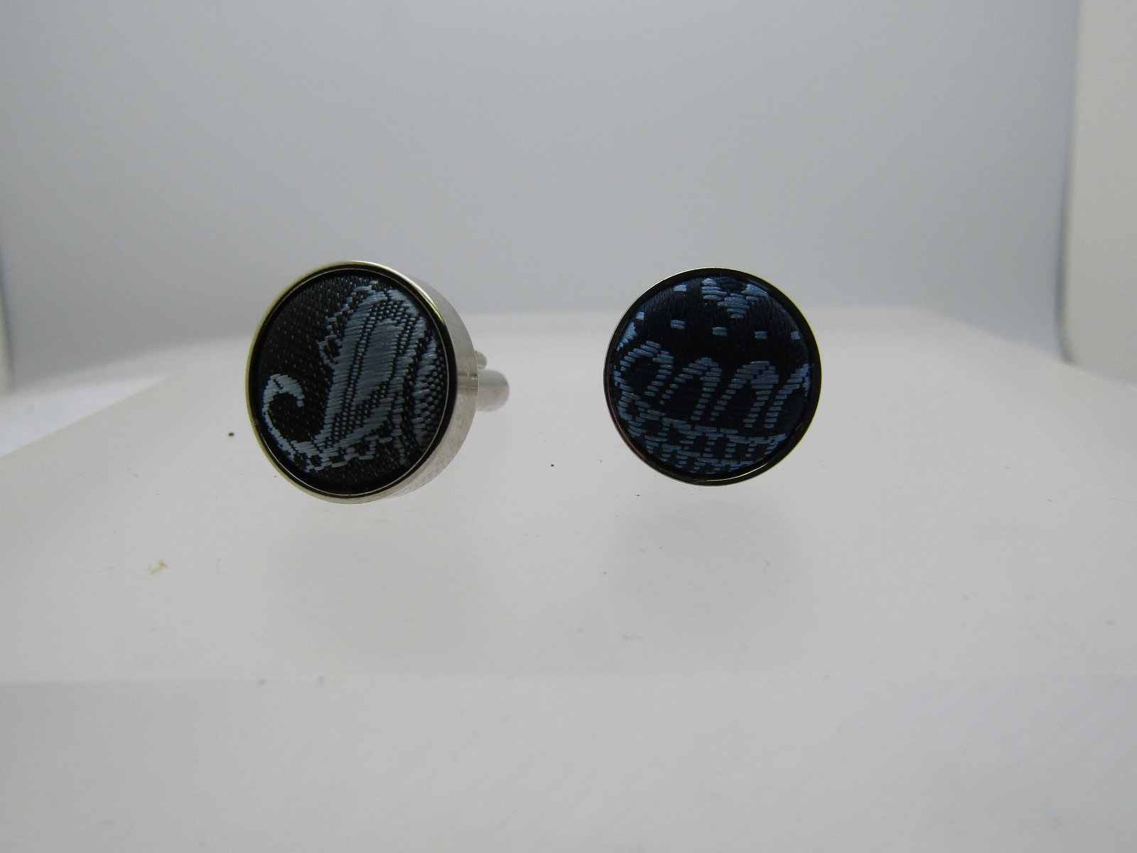 Vintage Silver tone Blue Paisley Cufflniks, 1960's-1970's: Vintage Silver tone Blue Paisley Cufflniks, 1960's-1970's. Slightly over 1/2" round with a woven fabric in black and light blue with a paisley pattern. Unisex. They are not signed by the maker. Very g