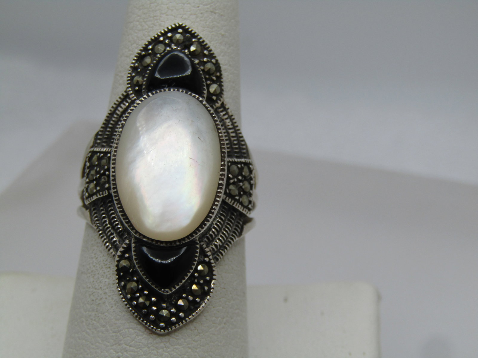 Vintage Sterling Onyx Marcasite Brooch, 1980's: Vintage Sterling Onyx Marcasite Brooch, 1980's or earlier. It has a raised bezel-set black onyx stone that is appx. 19mm by 12mm and it sits up appx. 5mm on the top of the slightly domed base. It