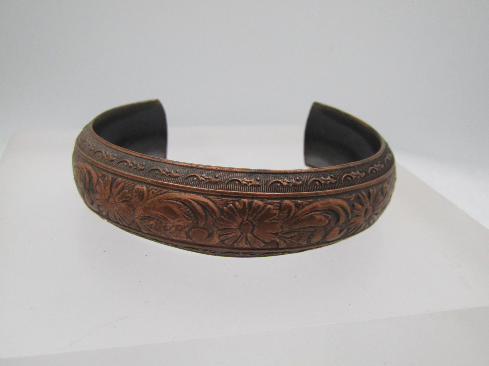 Vintage Copper Enameled Cuff Bracelet, Matisse Renoir, Unisex, 6.5, 1950's-1960's: Vintage Solid Copper Floral Bracelet, 6.75", 1960's. the bracelet is domed with a raised floral design at enter and a ridged background with scrolls on the edges. 5/8" wide and it is 6.75" which inclu