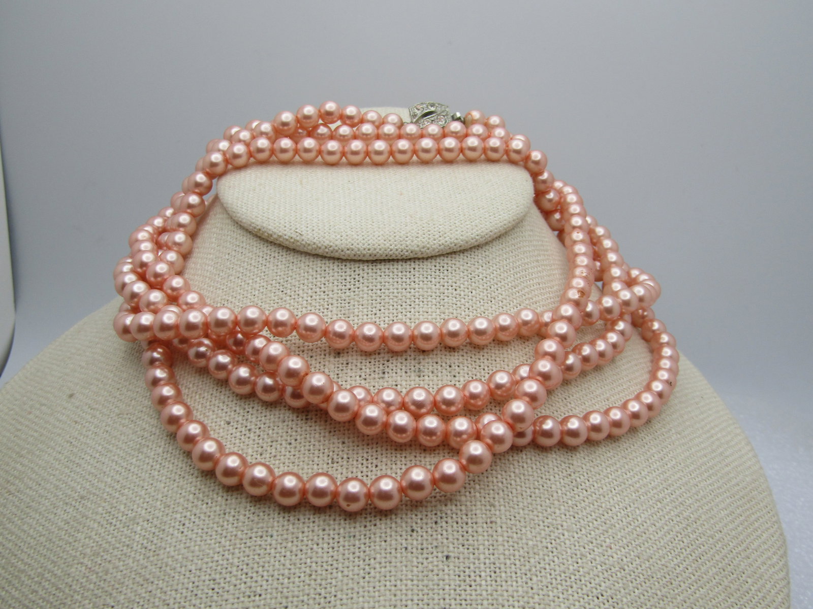 Vintage Faux Pink Pearl Necklace, 54", Rhinestone Clasp, 1960's: Vintage Faux Pink Pearl Necklace, 54", Rhinestone Clasp, 1960's. The pearls are appx. 6mm and a shimmery pink with a silver tone box clasp with four rhinestones. It is not signed or marked. It can