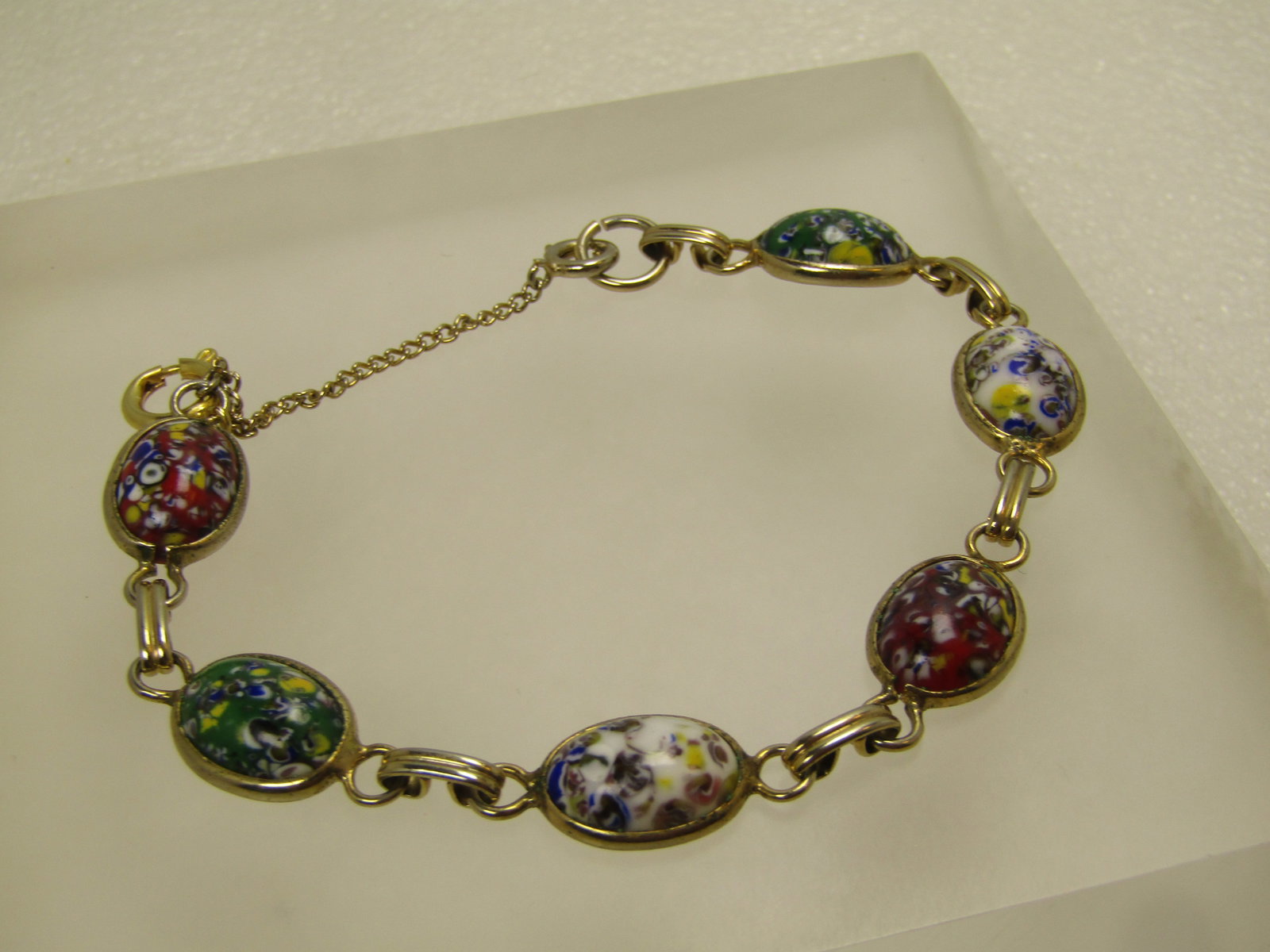 Vintage Venetian Glass Style Bracelet, 7.5", 1960's-1970's: Vintage Venetian Glass Style Bracelet, 7.5", 1960's-1970's. This has six links with mixed colored Venetian glass style oval 12mm by 9mm glass cabochons that are sent in a bezel around the base of