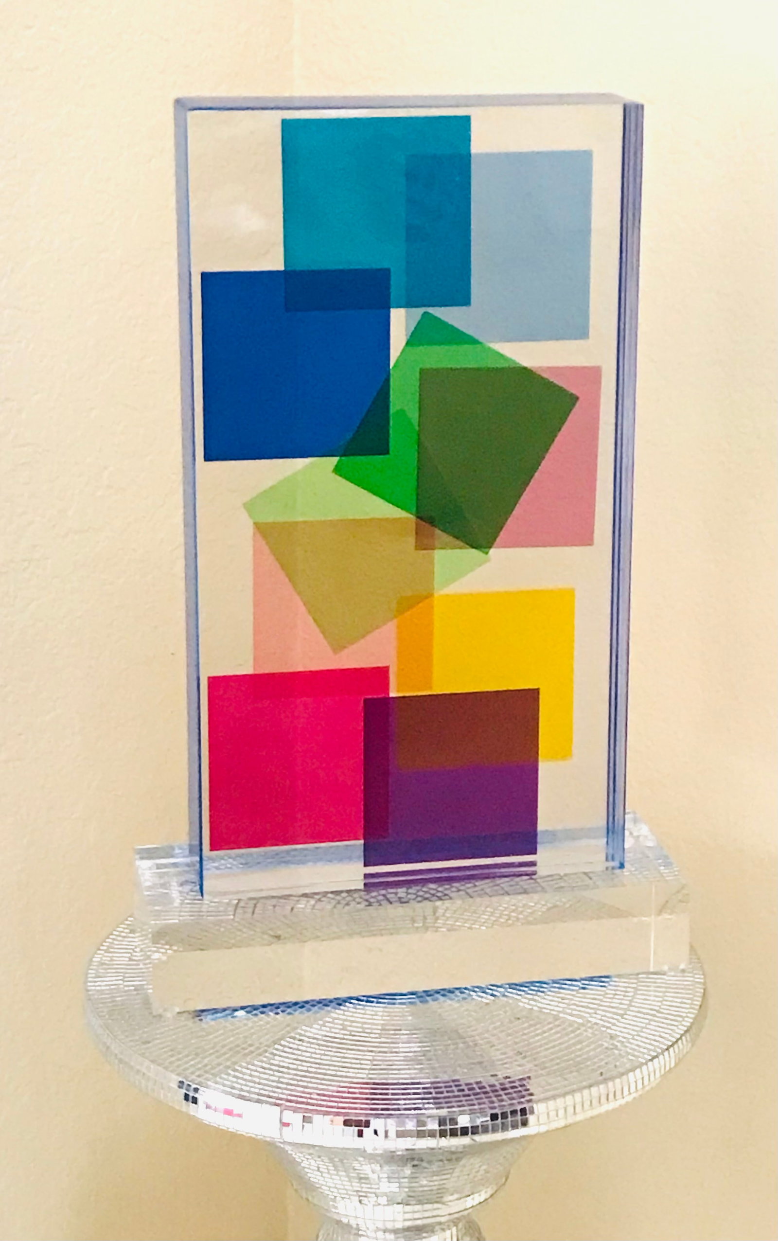 Lucite Acrylic sculpture Multi Color by Grace Absi: Title: Lucite Acrylic sculpture Multi Color by Grace Absi Description: A sculpture of a Lucite block handcrafted in the interiors with a geometric motif, laminated together on a clear, thick base, and