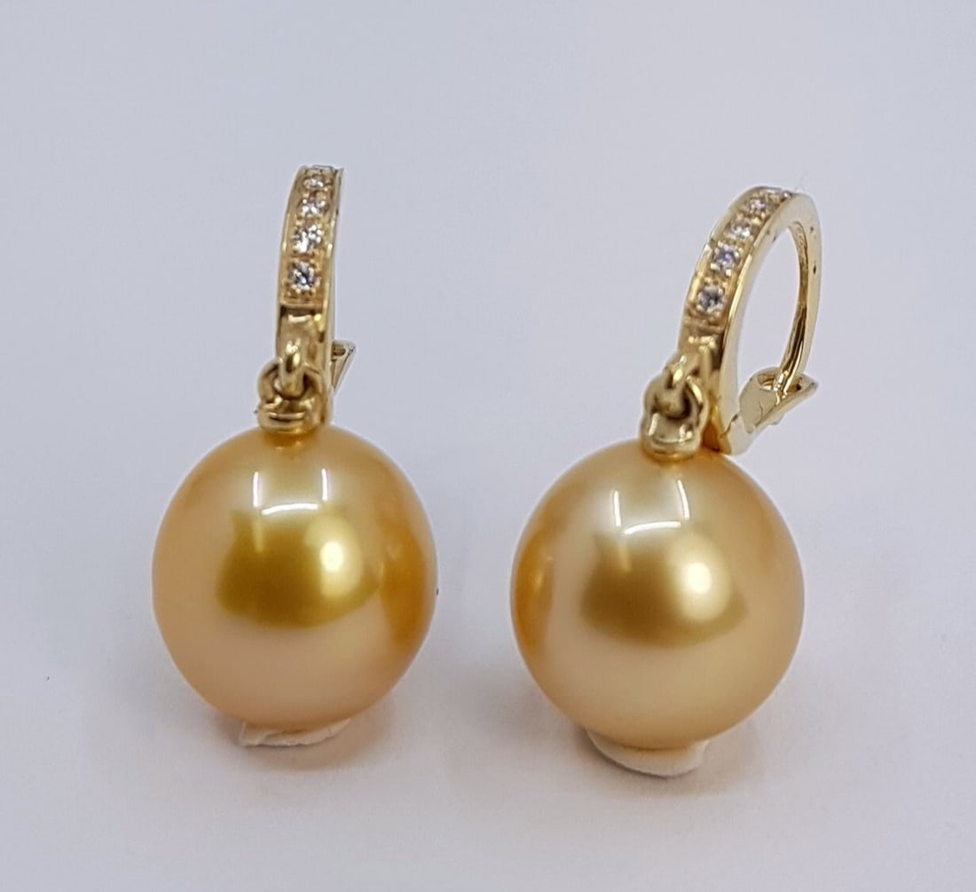 Earrings - 14 kt. Yellow gold - 0.09ct. tw. - 10x11mm: Title: Earrings - 14 kt. Yellow gold - 0.09ct. tw. - 10x11mm Description: Produced by the gold-lipped Pinctada Maxima Oyster in the warm waters of Indonesia, these pearls have a natural magnificent
