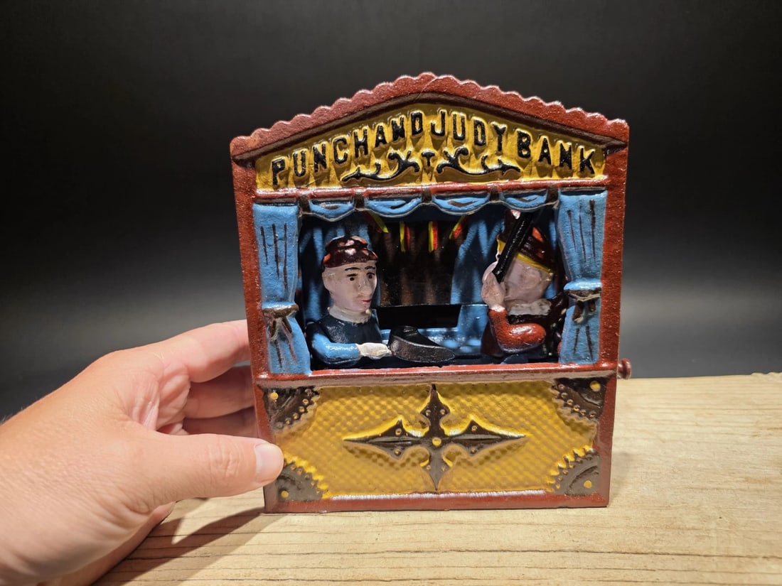 Punch and Judy Cast Iron Mechanical Coin Bank: Title: Antique Style Cast Iron Mechanical Coin Bank Description: Cast Iron Mechanical Coin Bank – Antique Reproduction Punch and Judy mechanical coin bank styled after late 19th-century American