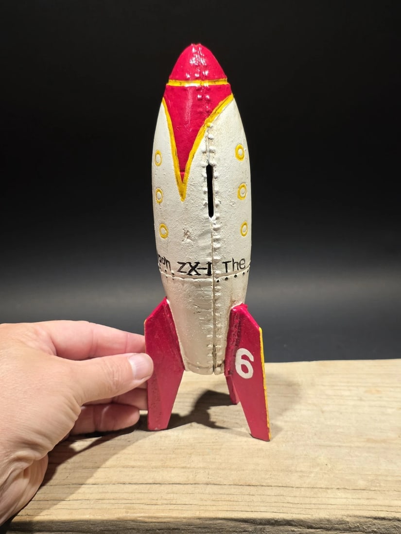9" Cast Iron Moon Rocket Coin Bank: Title: 9" Antique Style Cast Iron Moon Rocket Coin BankDescription: Rocket-form coin bank inspired by mid-century Space Age toys and novelty banks produced during the 1950s–1960s, when public