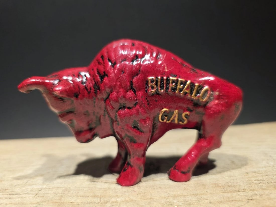 Buffalo Gasoline Cast Iron Coin Bank: Title: Antique Style Buffalo Gasoline Cast Iron Coin BankDescription: Buffalo Gas Cast Iron Coin Bank – Vintage-Style Red Buffalo Reproduction This cast iron coin bank is a reproduction of