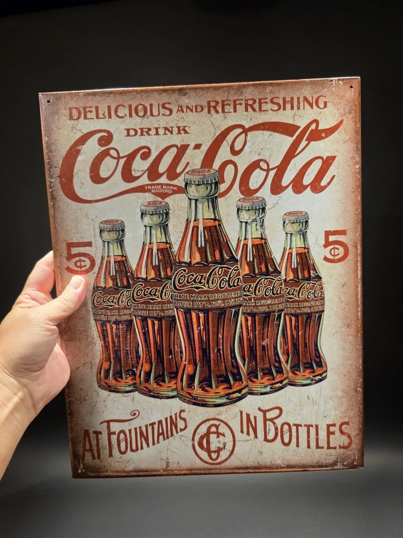 Coca Cola Bottles Sign: Title: Metal Vintage Style Coca Cola Bottles Sign Description: 16" x 12 1/2" Coca-Cola advertising tin sign featuring the classic “Delicious and Refreshing” slogan and an illustration of e
