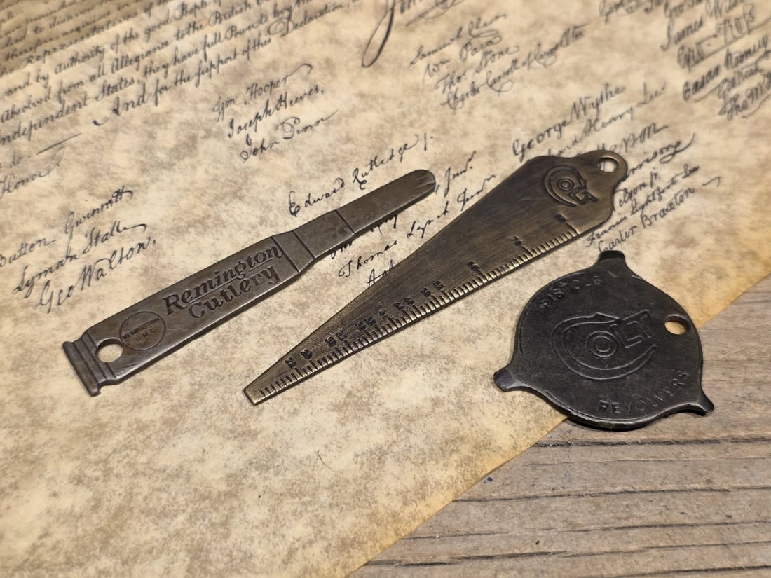 Colt, Remington Firearms Keychain Tool Set: Title: Vintage Style Colt, Remington Firearms Keychain Tool SetDescription: Nice Reproduction Colt advertising screwdriver, bore gage and Remington blade opener. Great for a key ring comes in handy! 