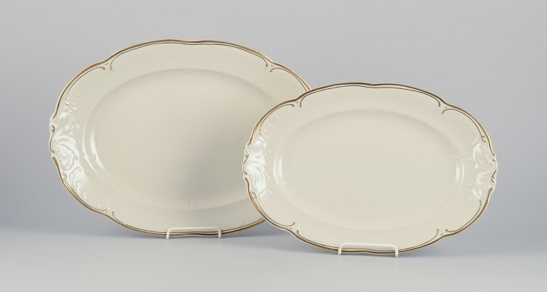 KPM, Poland. Two large oval porcelain serving platters. Cream-colored with gold rim decoration.: Title: KPM, Poland. Two large oval porcelain serving platters. Cream-colored with gold rim decoration. Brand: Various Description: KPM, Poland. Two large oval porcelain serving platters.