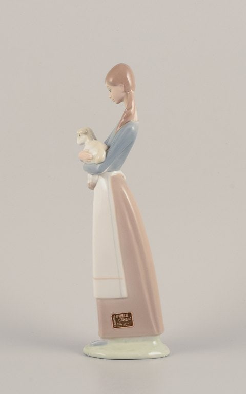 Lladro, Spain. Porcelain figurine of a standing young woman holding a lamb in her arms. - 2