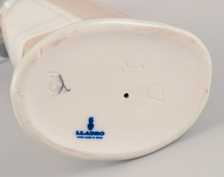 Lladro, Spain. Porcelain figurine of a standing young woman holding a lamb in her arms. - 8