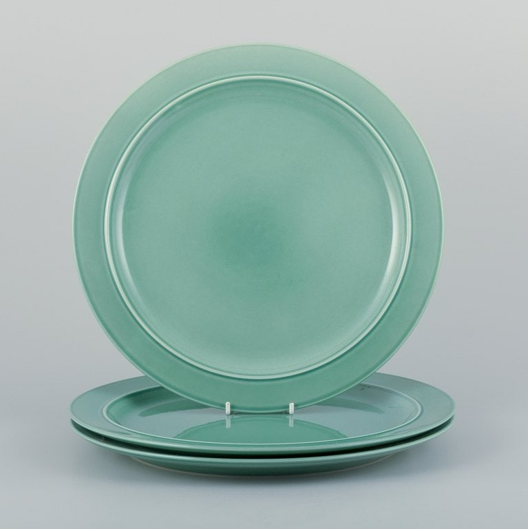 Royal Copenhagen, "4 All Seasons". A set of three dinner plates in faience with green glaze. (1 of 5)