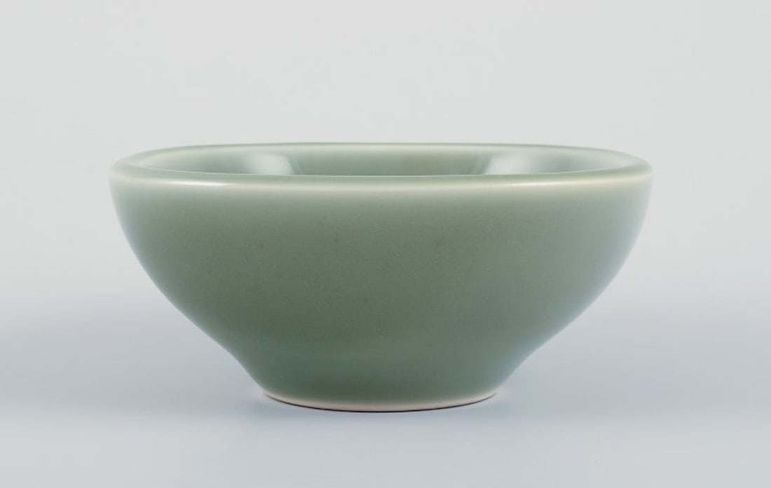 Nils Thorsson for Royal Copenhagen. Ceramic bowl in celadon glaze. Featuring a fish motif. Mid-20th - 2