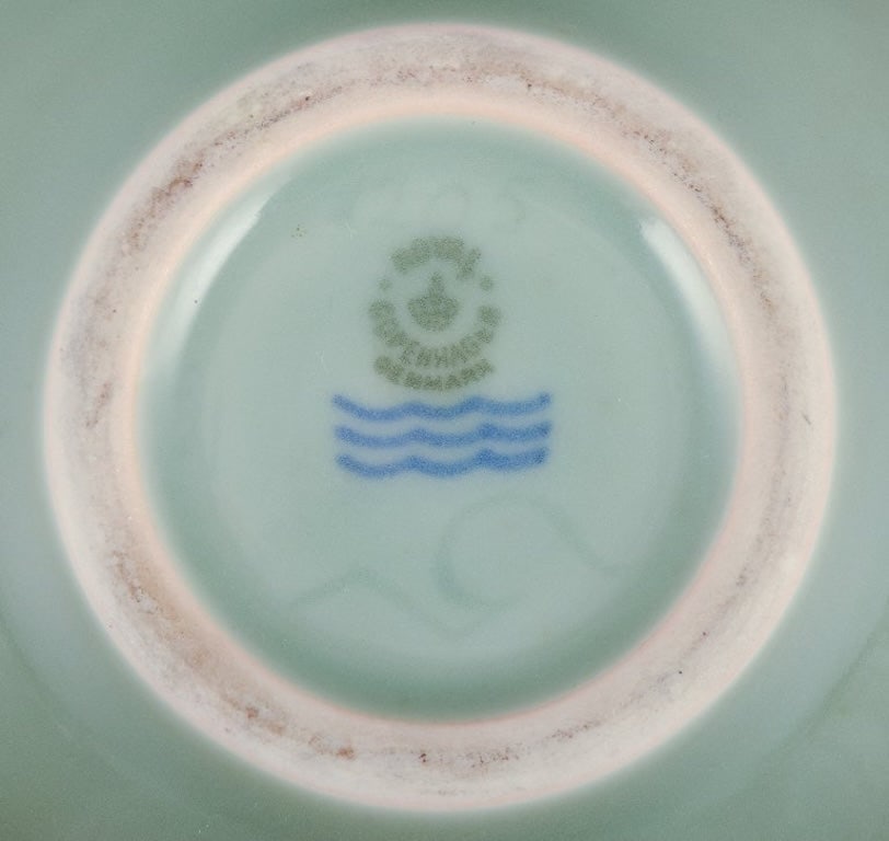 Nils Thorsson for Royal Copenhagen. Ceramic bowl in celadon glaze. Featuring a fish motif. Mid-20th - 5