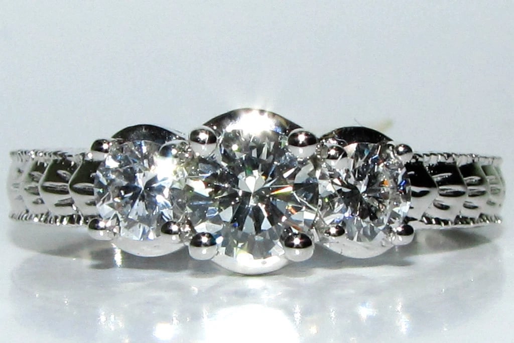 1.09CT NATURAL DIAMONDS CLASSIC 3 RING 14KT**: Title: 1.09CT NATURAL DIAMONDS CLASSIC 3 RING 14KT** Description: ONLY MAGNIFICENT JEWELS The classic 3 .58ct. center round diamond I color Vs-2 clarity side (2) diamonds: .51ct. H-color vs-2 clarity