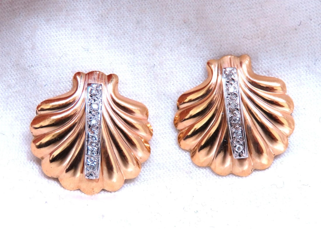 .06ct Natural diamond earrings 14kt yellow gold**: Title: .06ct Natural diamond earrings 14kt yellow gold** Description: Shell Form diamond earrings. .06 carat natural round diamonds H - color si-1 clarity 14 karat white gold 2.6 grams Earrings measur