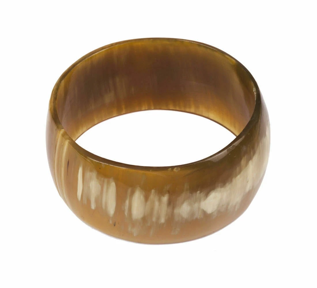 Massive Cow Horn Bangle Bracelet: Title:Massive Cow Horn Bangle Bracelet Description:Amazing, smoothly finished bangle bracelet made of cow horn. Circa, 1970's. Bracelet is almost 1 ½” wide. Internally measures 3”.