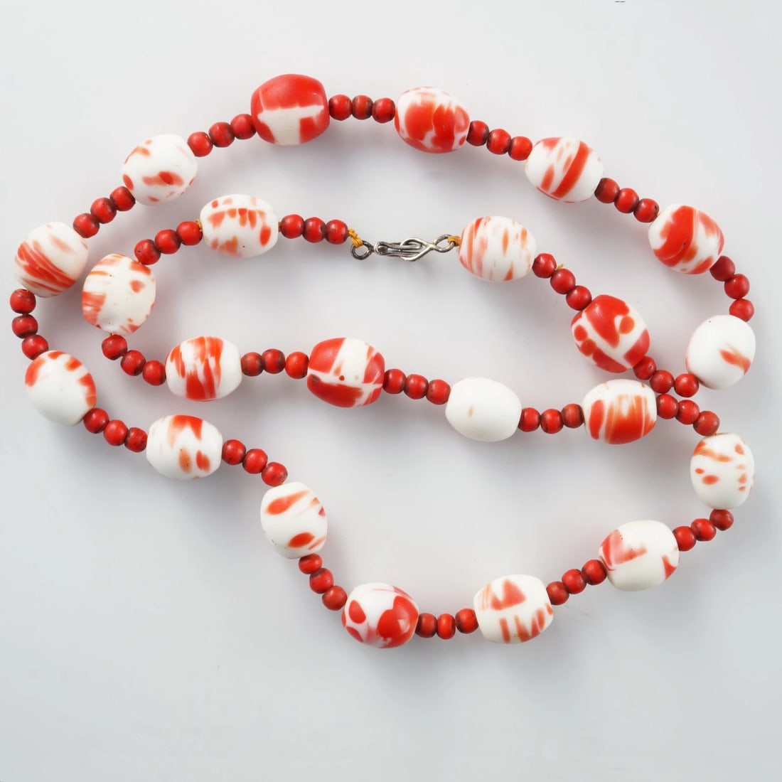 19th C Venetian Glass Trade Bead Necklace: Title:19th C Venetian Glass Trade Bead NecklaceSize:27 in (68.9 cm) long. Hangs 13 ½ in (34.3 cm).Description:A colorful necklace made with small red and larger red swirled Venetian glass