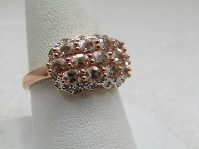 Sterling Peach & Clear CZ Ring, Rose Gold Tone, Sz. 9.5: Sterling Peach & Clear CZ Ring, Rose Gold Tone, Sz. 9.5. There are 13 pale peach stones that are appx. 4mm by 2.5mm set on the side and on each side fo the ring is a silver scalloped setting where a s