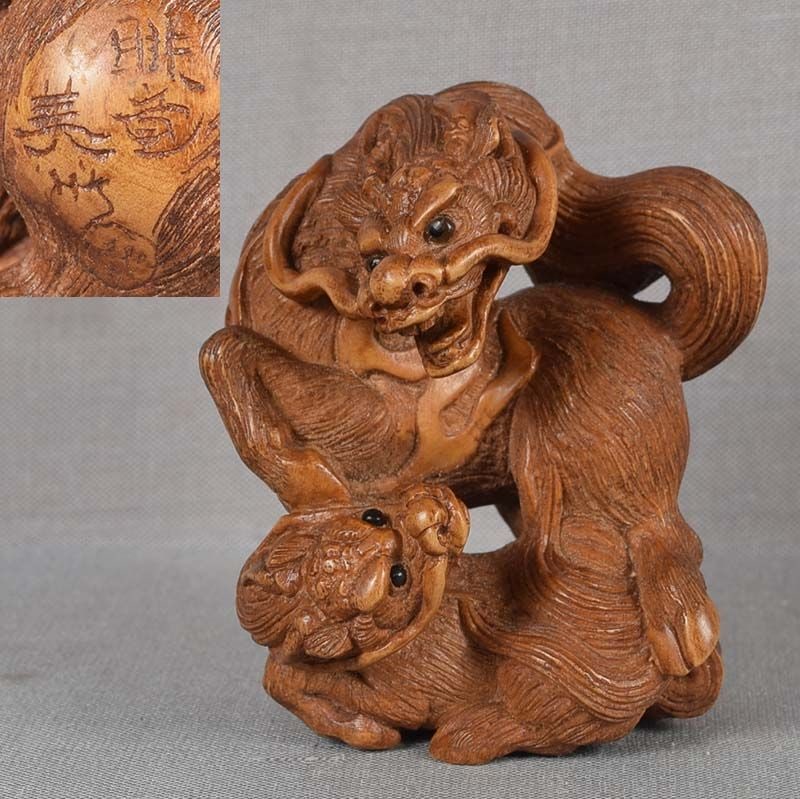 Netsuke KIRIN & young by BISHU: Boxwood netsuke of mother kirin standing above its young. Superb carving to the last detail with absolutely great faces and realistic rich hairwork. Clever composition with dynamic postures, perfectly