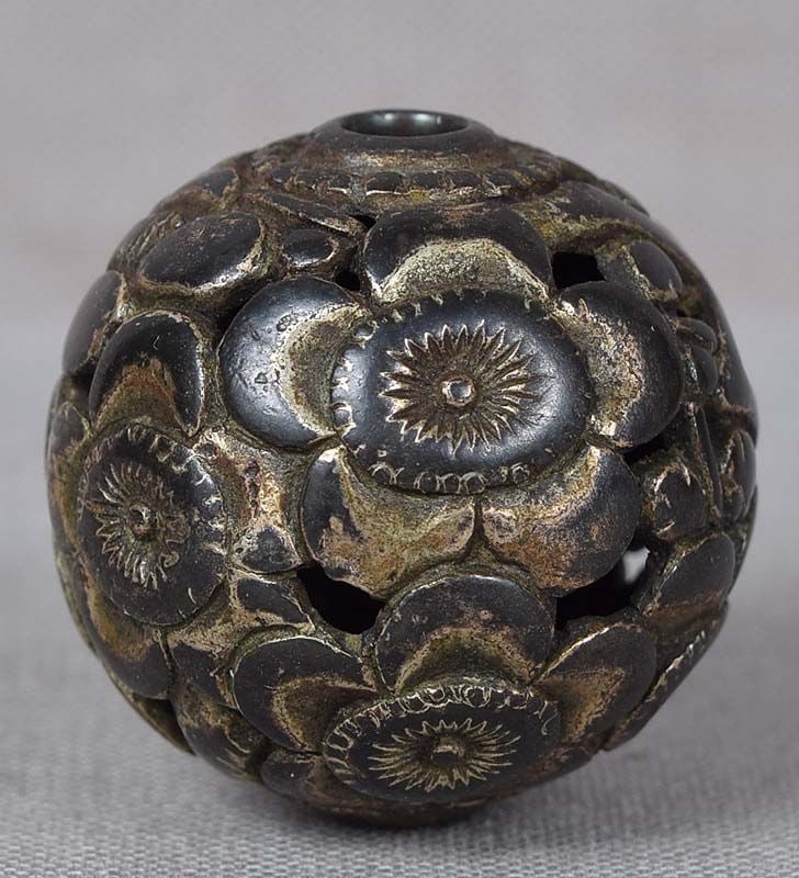 19c metal OJIME netsuke slide CHERRY FLOWERS: 19th century metal ojime (slide bead for tightening the cord going from netsuke to inro) in ball shape with pierced decoration of continuous open cherry flowers. Superb design, full liner to the centr