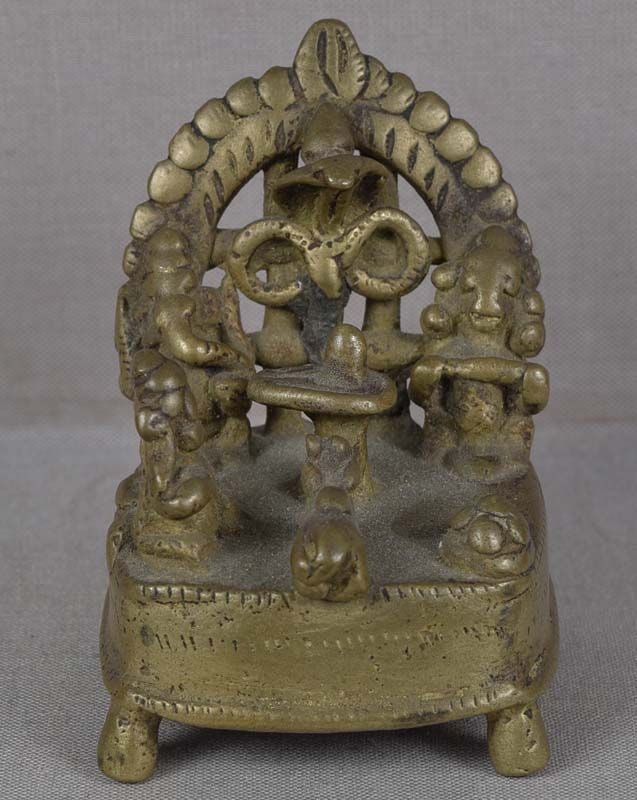 18c Indian bronze SHIVA SHRINE Parvati Ganesha Nandi Naga: 18th century Indian bronze Shiva shrine from Western India in a form of a courtyard, the family of Shiva seated around a lingam, including his wife Parvati, their son Ganesha, and Nandi bull at the en