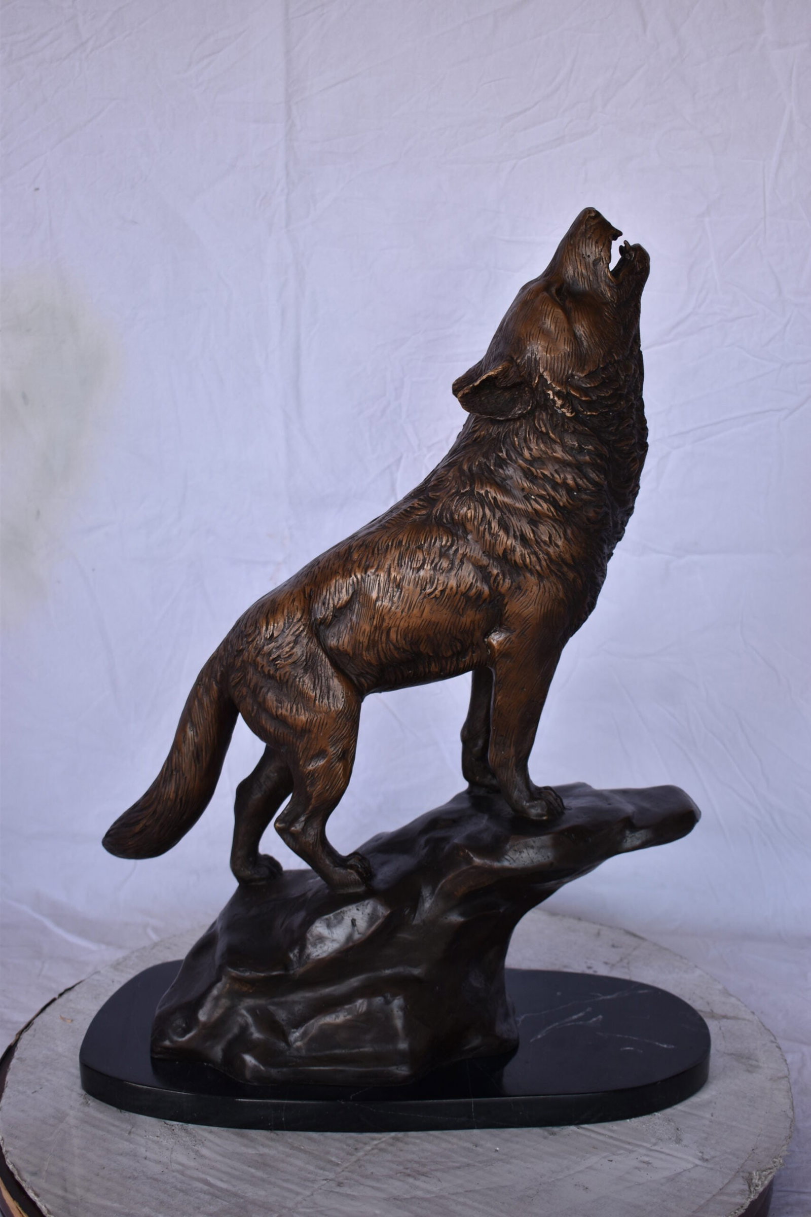 Howling Wolf at Edge of a Cliff Bronze Statue - Size: 9"L x 20"W x 26"H. - 2